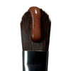 peptide lip tint honey mango on a brush