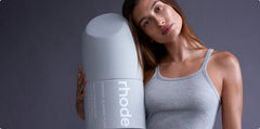 Hailey holding a large bottle of Peptide Glazing Fluid