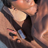 fatouma with terry towel, terry bag, peptide lip tint honey mango, pocket bronze, highlight milk 04